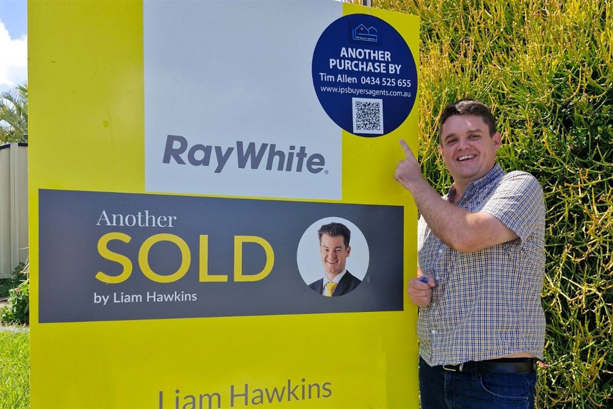 Tim Allen of IPS Buyer’s Agents beside the sold sign for 10 Corrimal Place, Sandstone Point, secured for a Sydney-based client